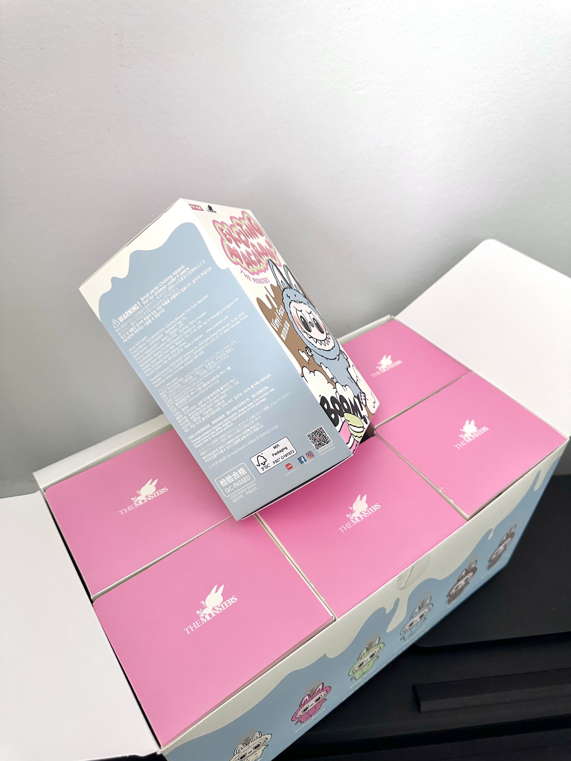 Unboxed pink and gray box with floral design on a white background