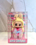 Toy figure in a bunny costume with a pink bow in clear packaging, featuring the brand 'Pop Mart'.