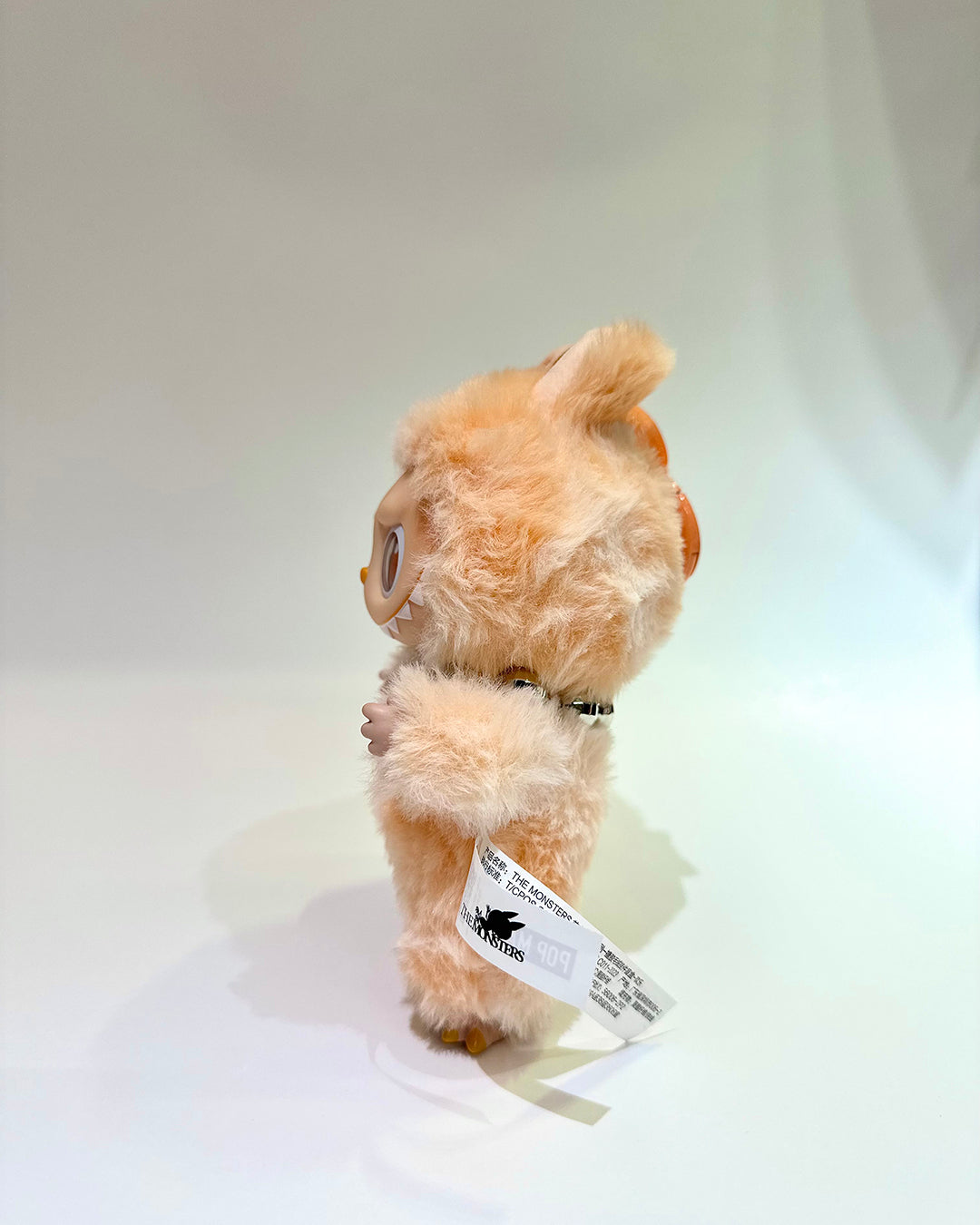 Plush toy with a tag on a white background
