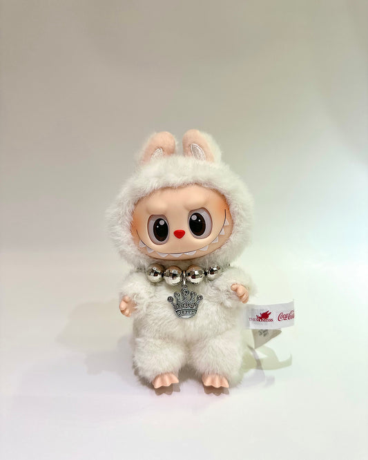White plush toy with a fluffy hood and bell on a white background