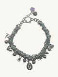 Silver necklace with charms on a white background