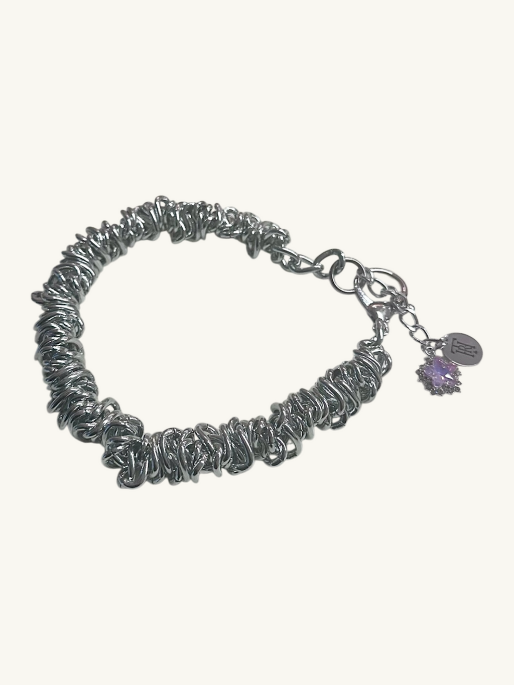 Silver bracelet with a charm on a white background