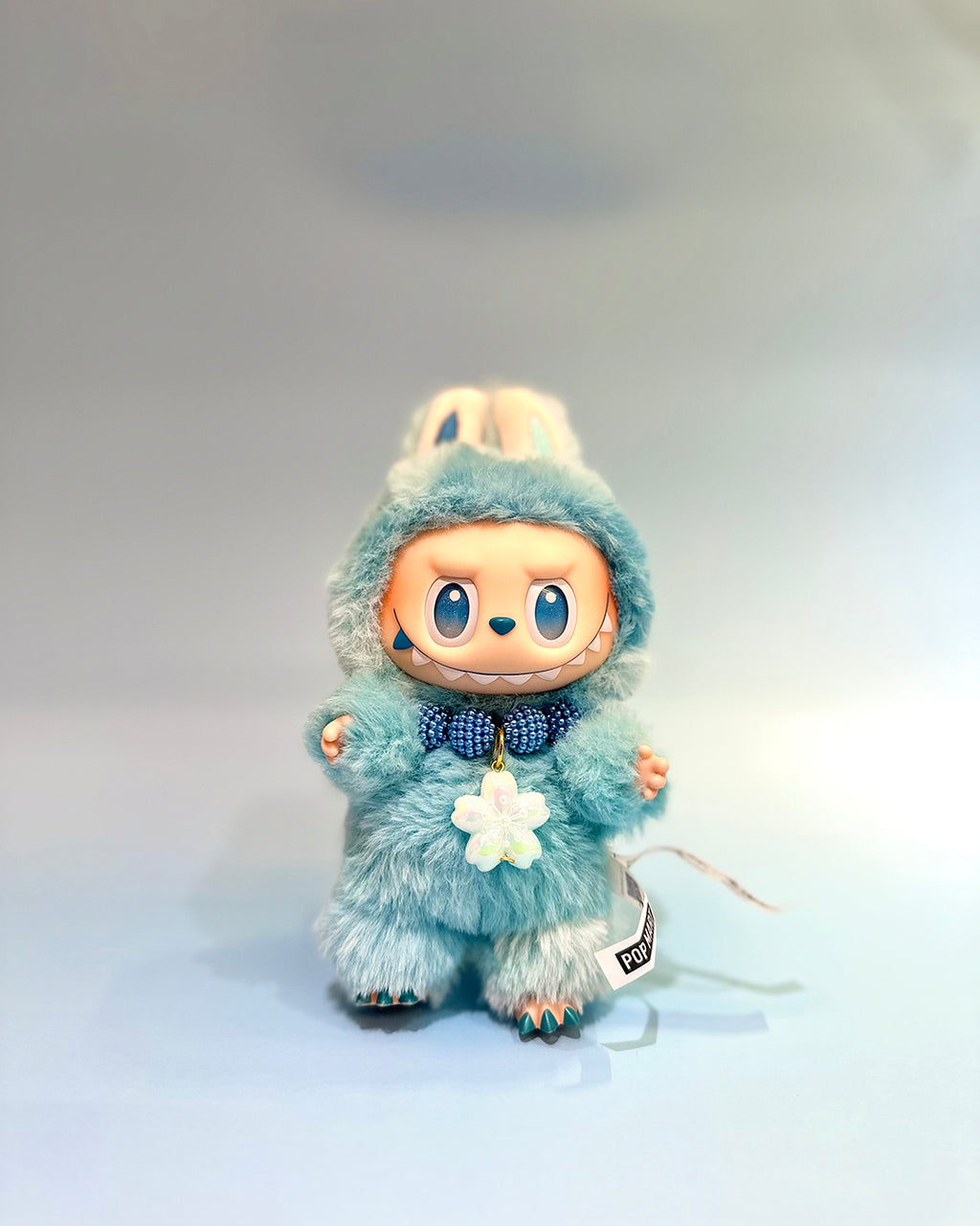 Toy figure in a blue outfit with a white background