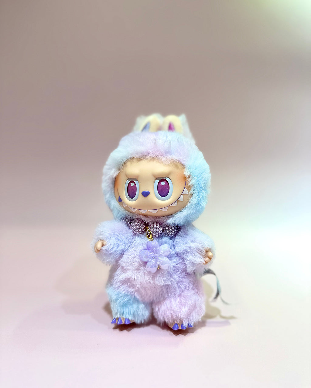 Plush toy with a blue and white fur coat on a light gray background