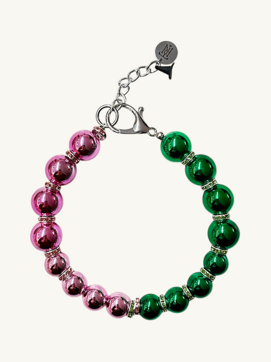 Bracelet with pink and green beads on a white background