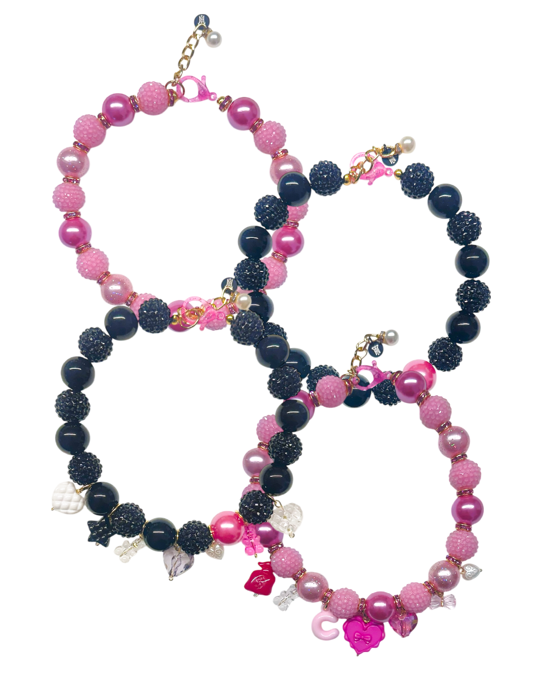 Set of pink and black beaded necklaces on a white background