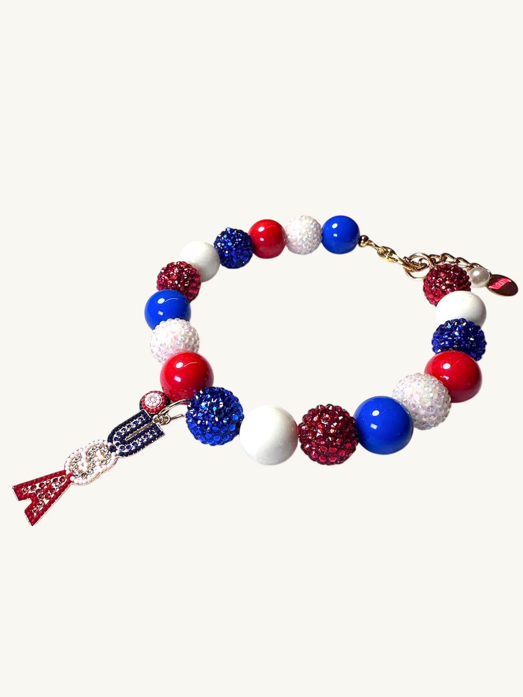 A pet luxury beaded necklace handmade in New York City in red, white, and blue with USA initial charm as part of The Haus Royale's The Americana collection