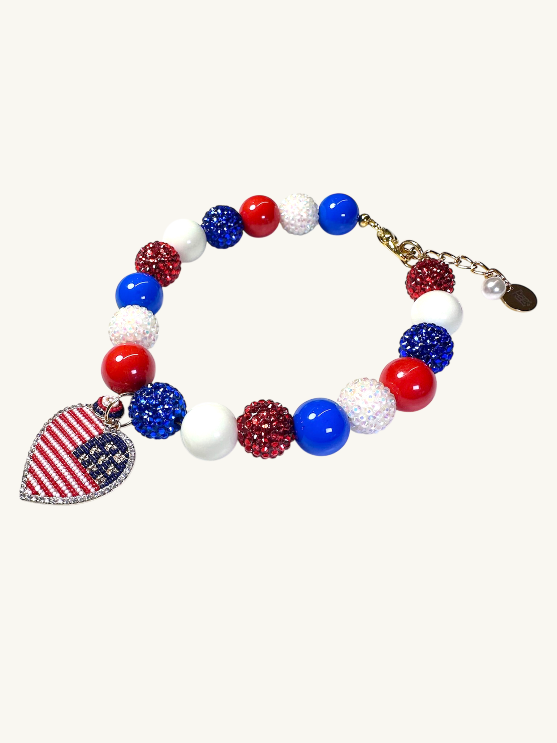 A pet luxury beaded necklace handmade in New York City in red, white, and blue with heart charm as part of The Haus Royale's The Americana collection