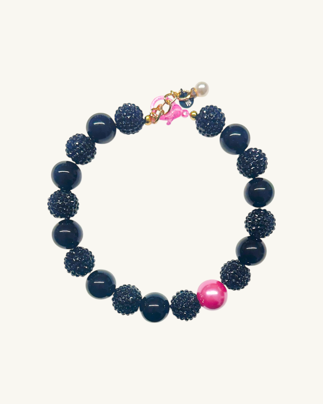 Navy blue beaded bracelet with pink accents on a white background