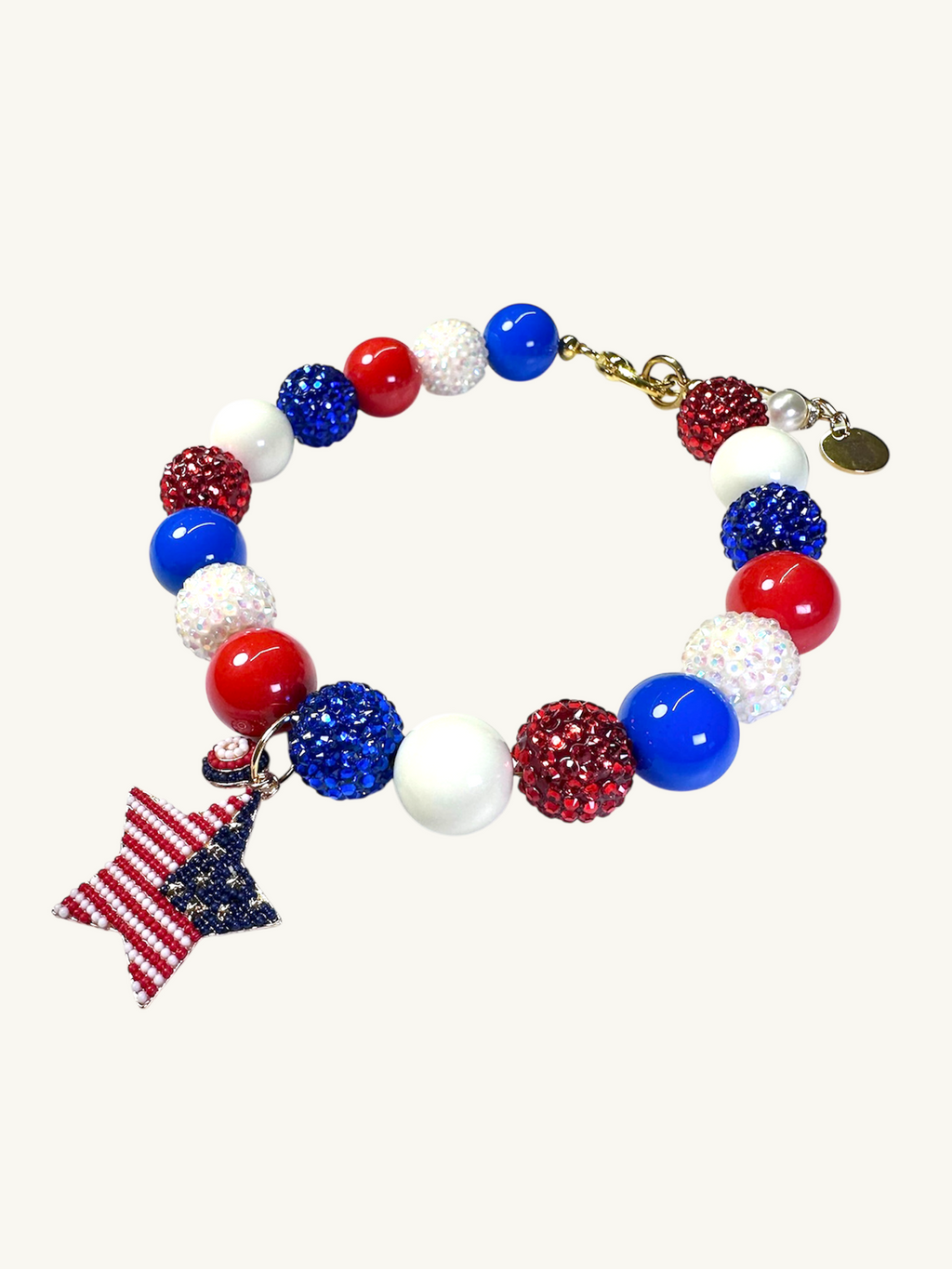 A pet luxury beaded necklace handmade in New York City in red, white, and blue with star charm as part of The Haus Royale's The Americana collection