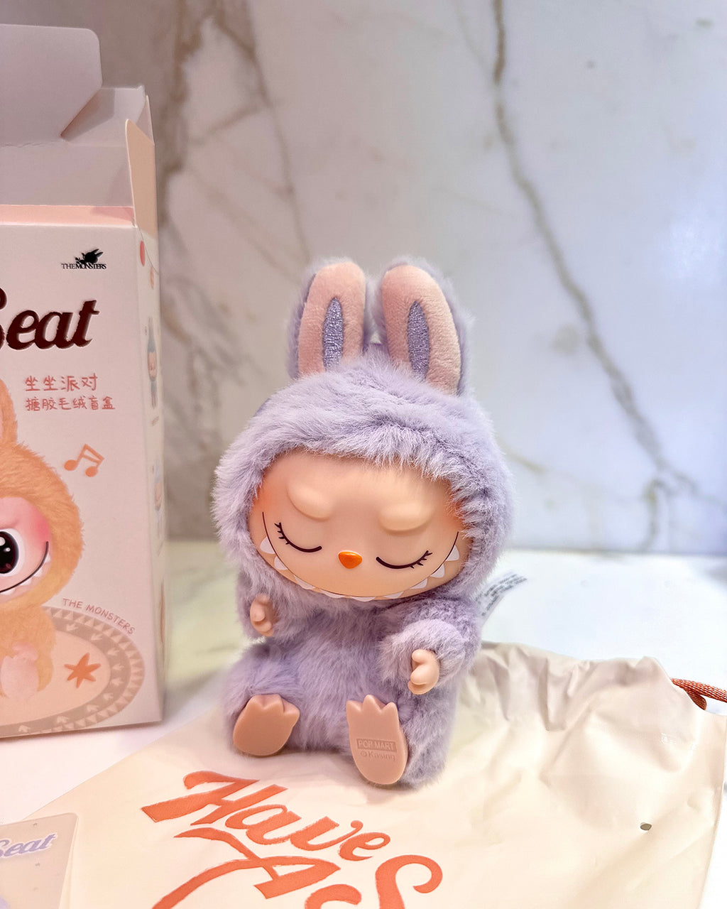 Plush toy in a purple outfit with a blurred background