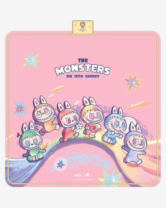Pink blanket with cartoon monsters and rainbow design on a white background