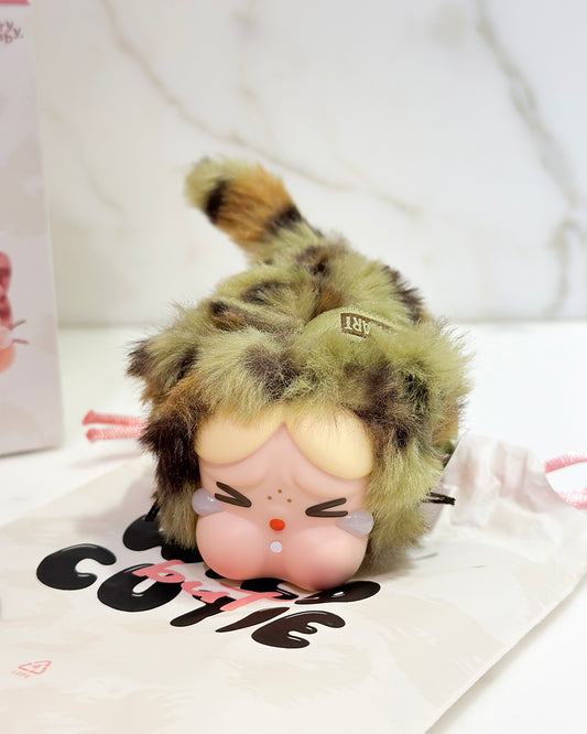 Plush toy with a leopard print hat on a white background