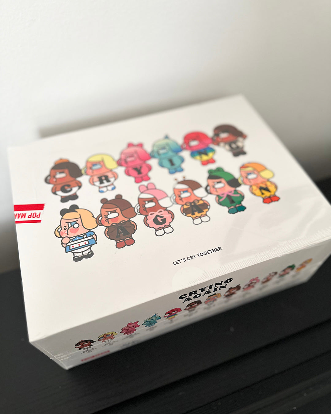Box with cartoon character designs and text on a white background
