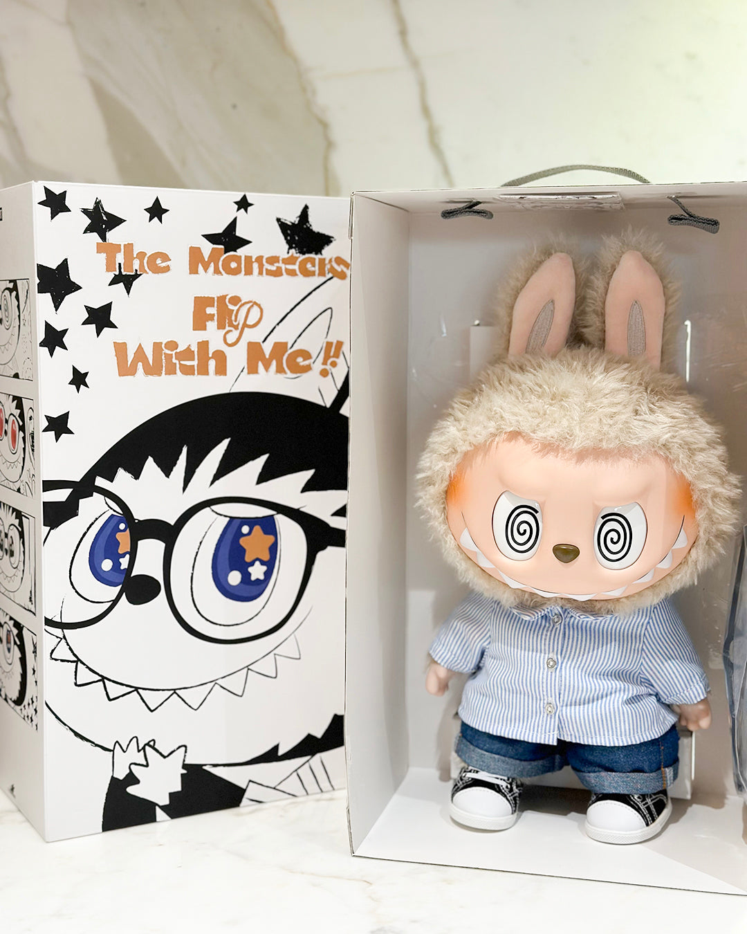 Toy figure with bunny ears in a box with cartoon character design