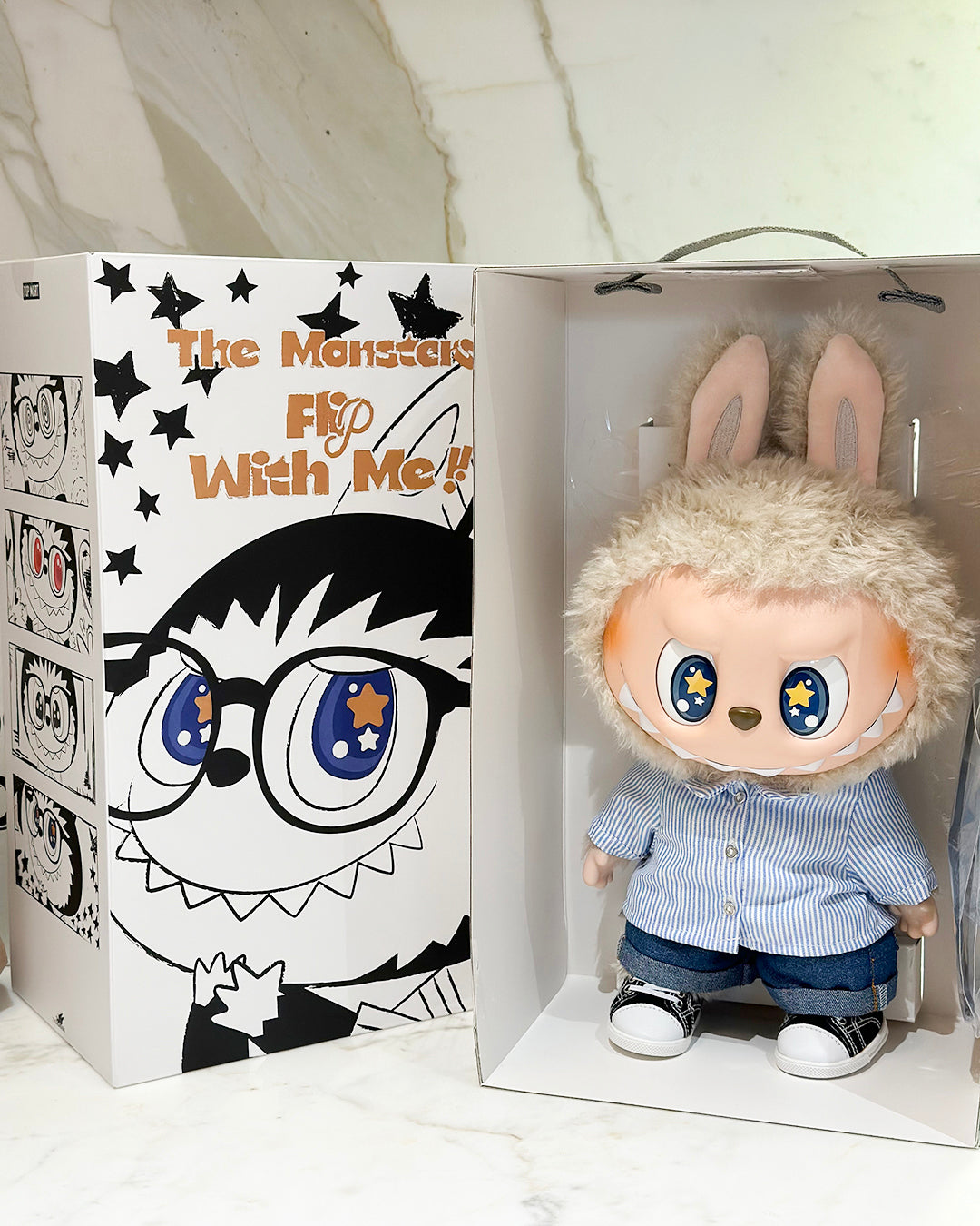 Toy figure with bunny ears in a box with cartoon face design