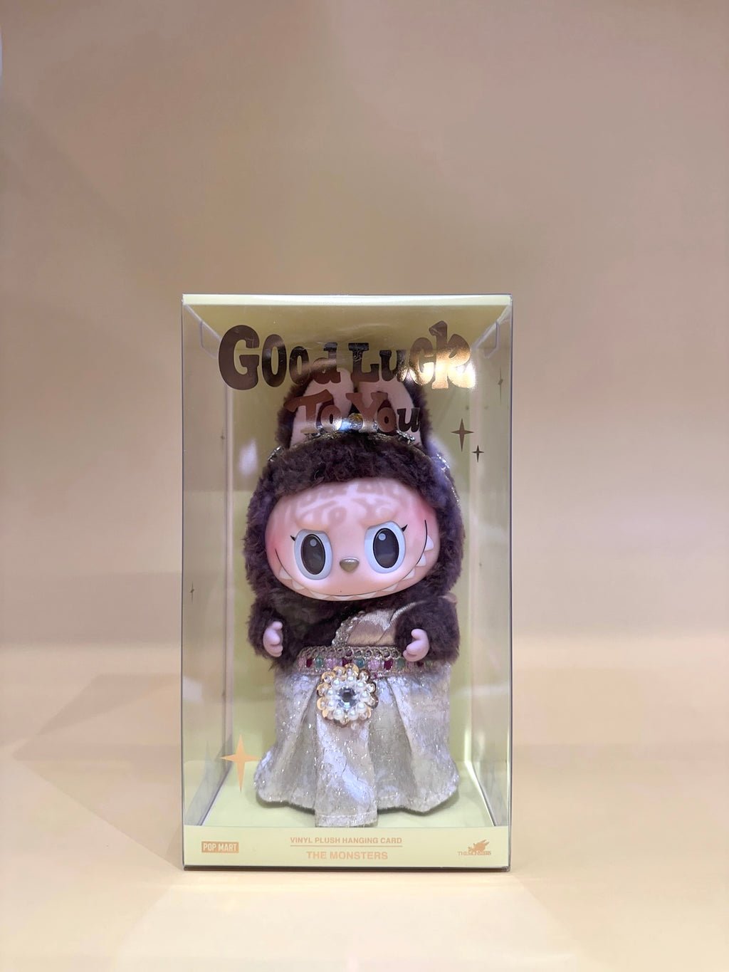 Plush toy with a decorative box labeled 'Good Luck' on a light background