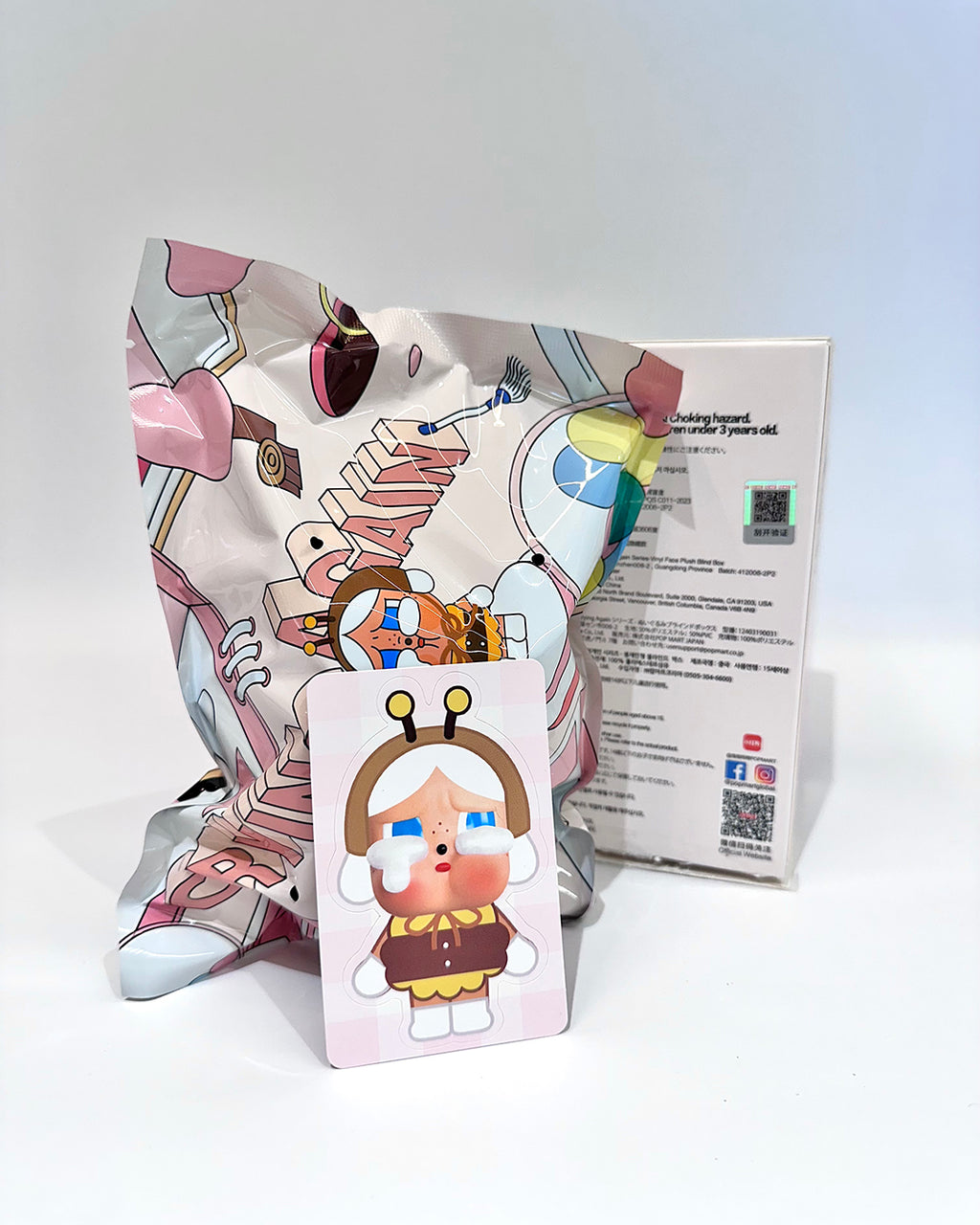 Colorful cartoon character pillow with packaging on a white background