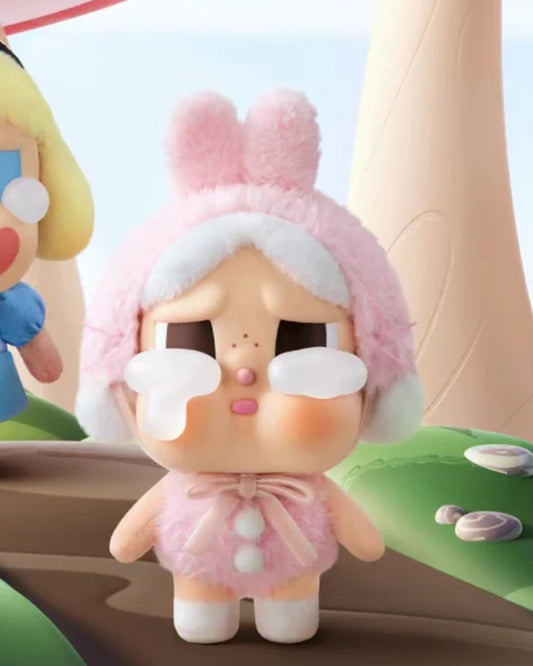 Toy figure with bunny ears and a pink outfit on a colorful background