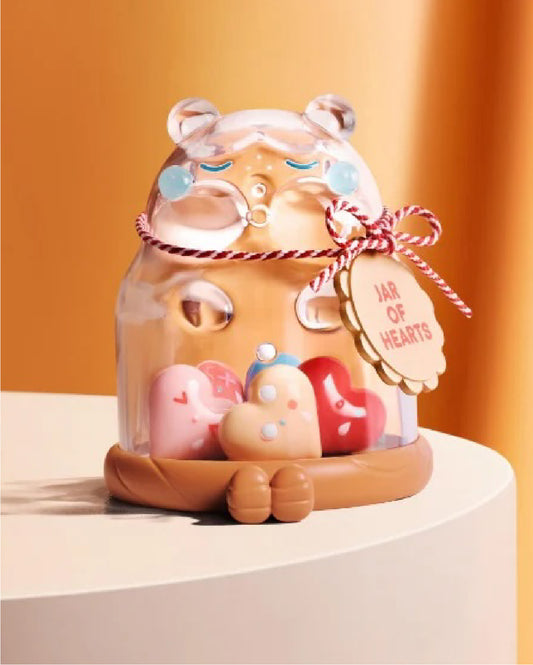 Cute bear-shaped jar with heart-shaped candies on a light orange background