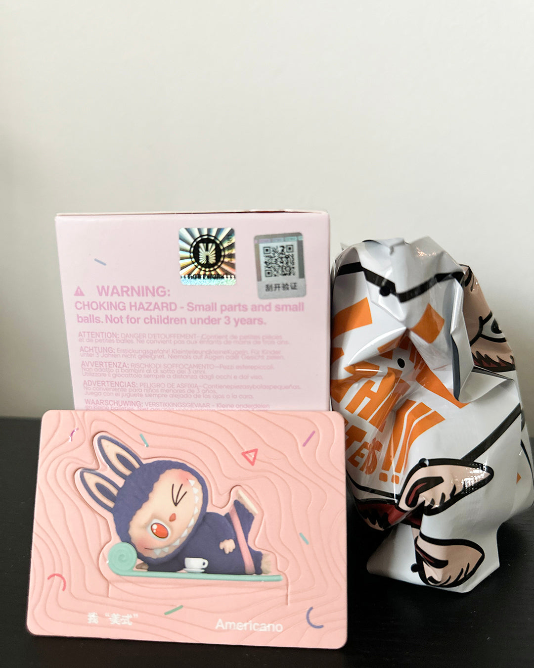Product packaging with a warning label and colorful design on a plain background