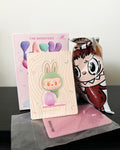 Cartoon character-themed products including a notebook and a mask on a reflective surface.