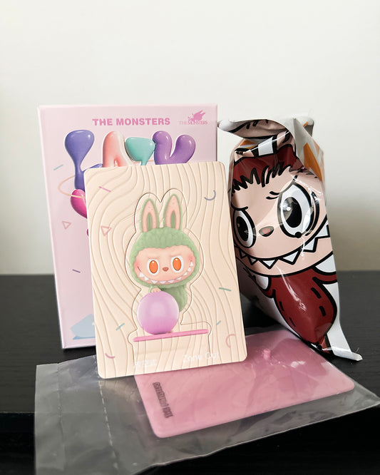 Cartoon character-themed products including a notebook and a mask on a reflective surface.