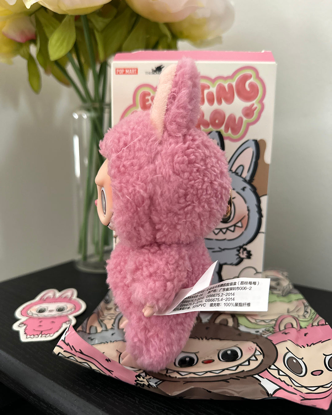 Pink plush toy with a cartoon character in front of a box labeled 'Gorillang'.
