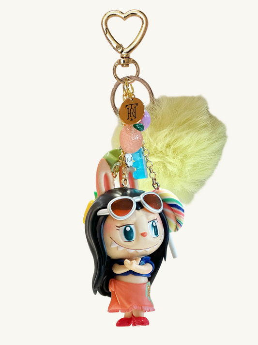 Keychain with cartoon character holding a colorful umbrella on a white background