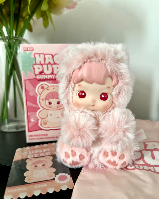 Fluffy pink plush toy with a box in the background