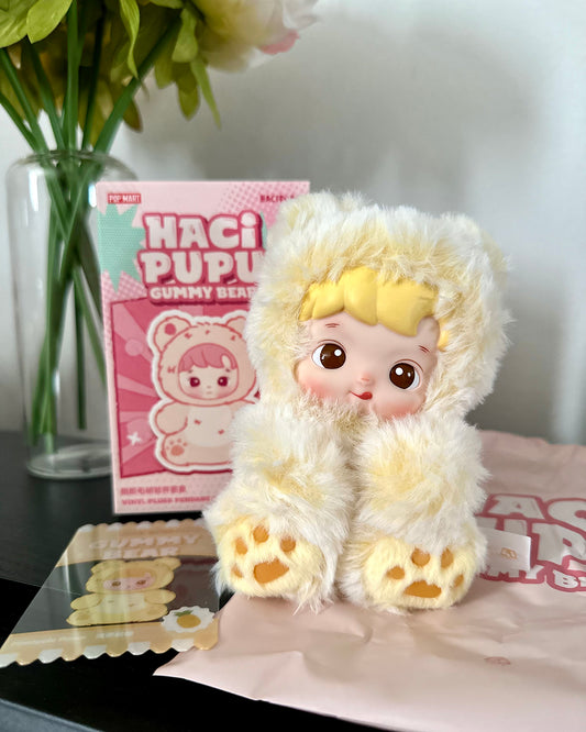 Plush toy with a cartoon character on a table with a box in the background