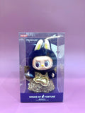 Toy figure in a clear packaging with 'Pronounce' branding on a purple background