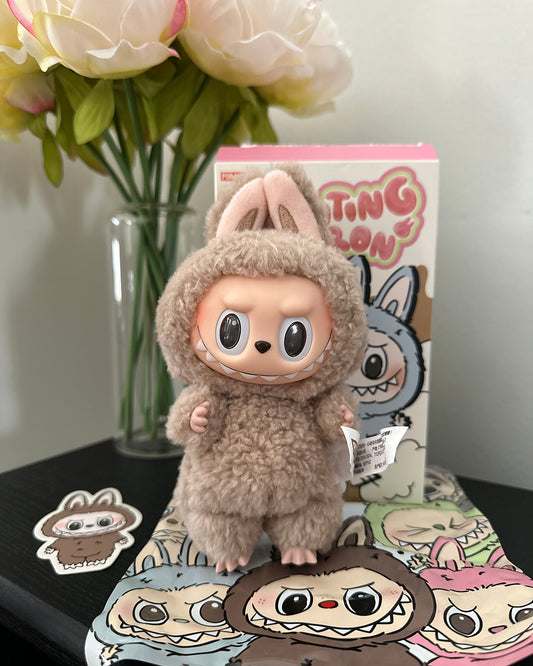 Plush toy in a costume with packaging and decorative items on a surface